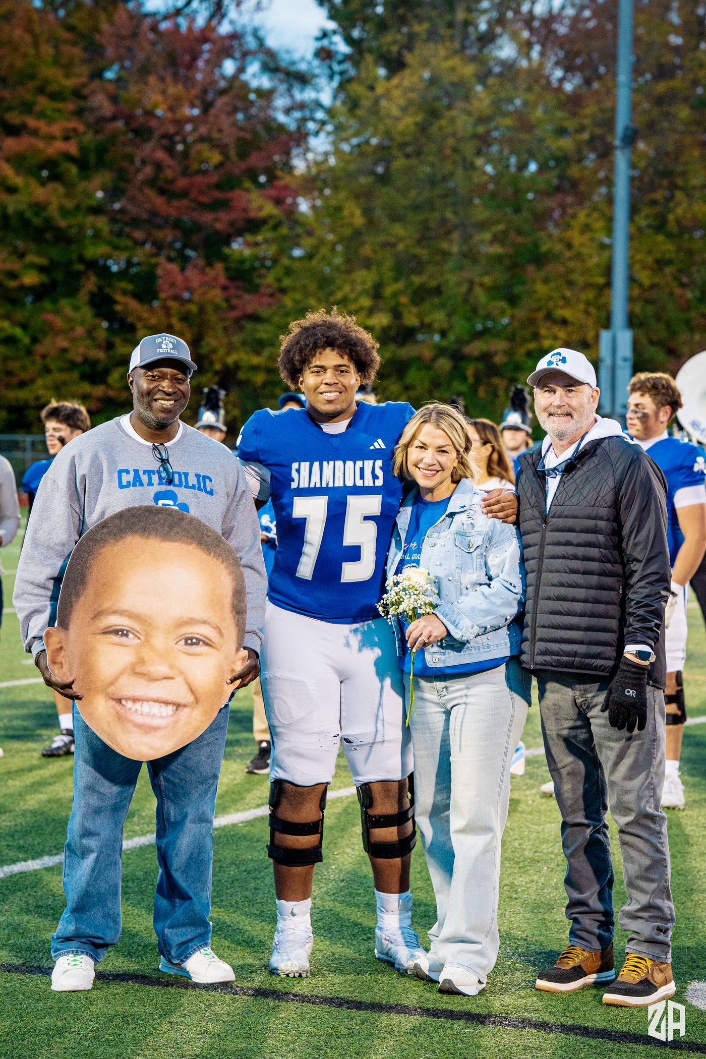Senior night at Detroit Catholic Central: Benjamin Eziuka in his blue Shamrocks number 75 jersey on the field with his family.