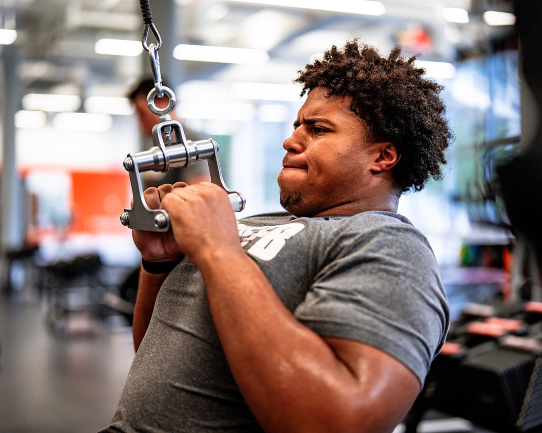 Benjamin Eziuka working a cable pull during a Virginia Tech strength session.